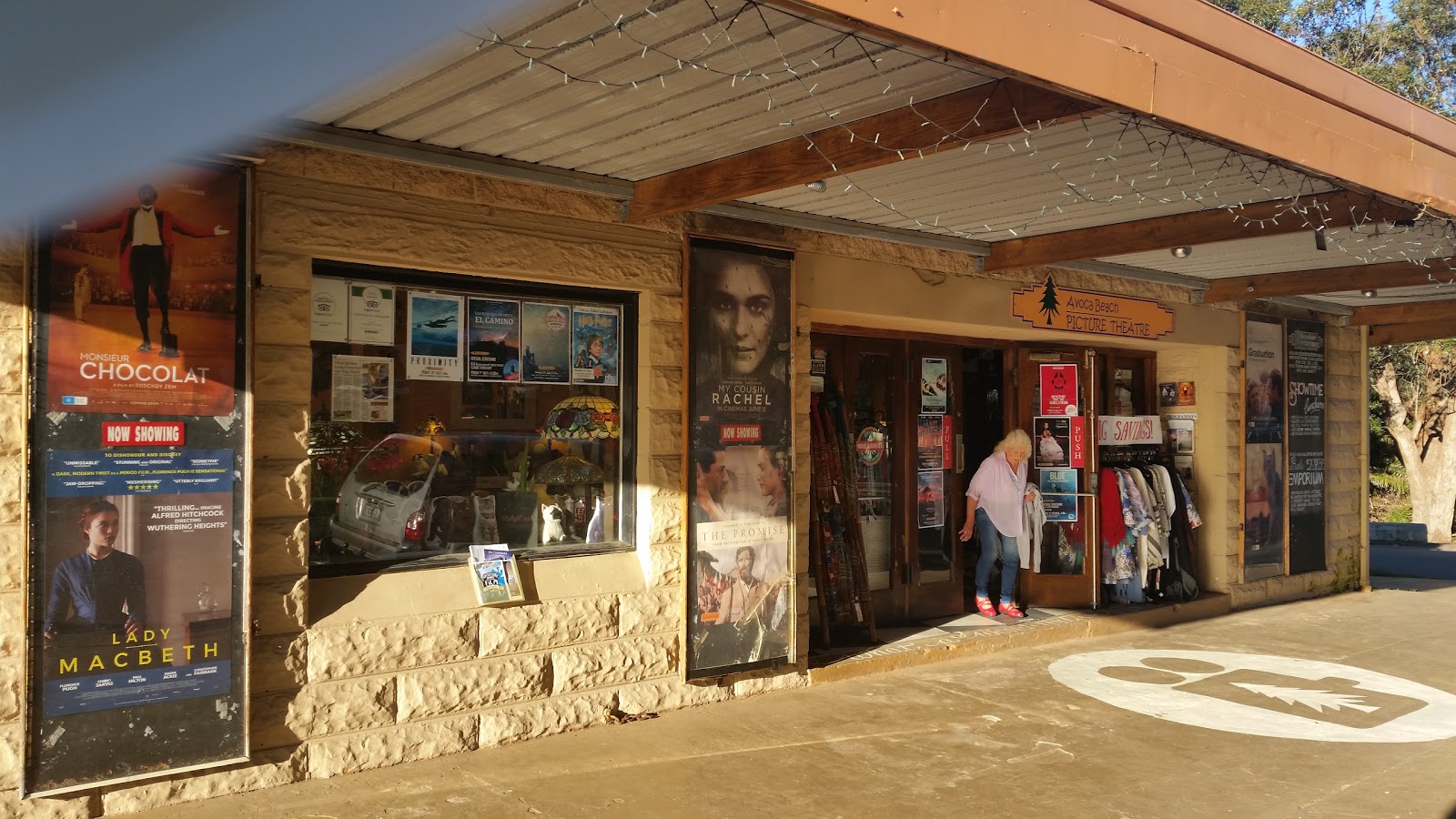 Entrance to the Art Deco Avoca Beach Picture Theatre, its facade covered in current film posters