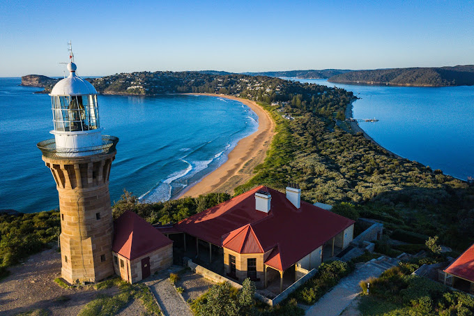 Aerial view of Barrenjoey Lighthouse and its keeper's cottages overlooking Palm Beach and Pittwater