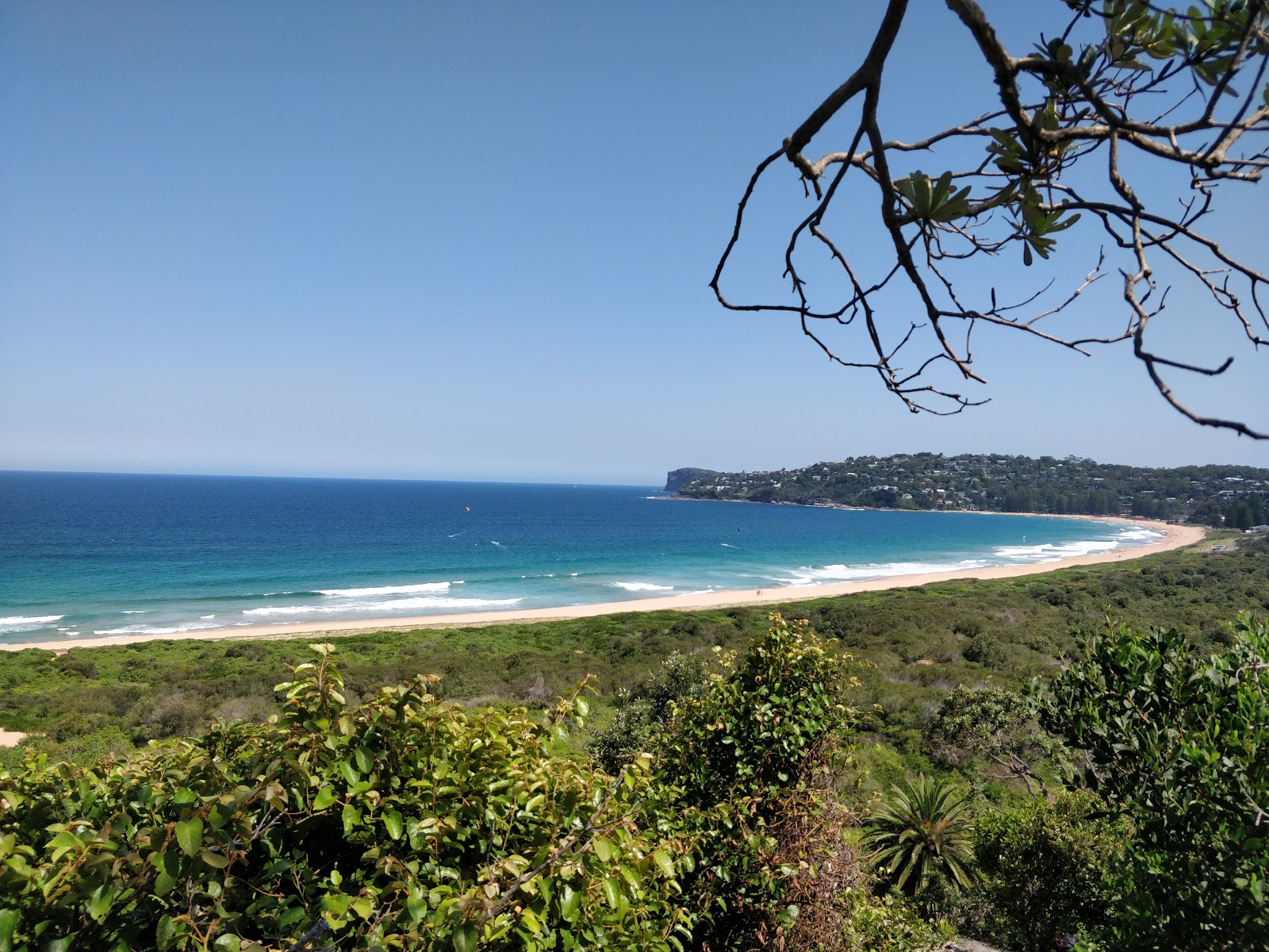 Sandstone rock platform and cove near Barrenjoey Headland, with a fisherman casting a line